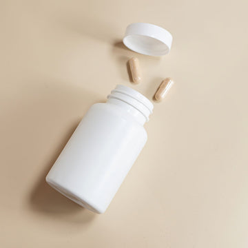 Berberine supplement bottle with capsules on a neutral background